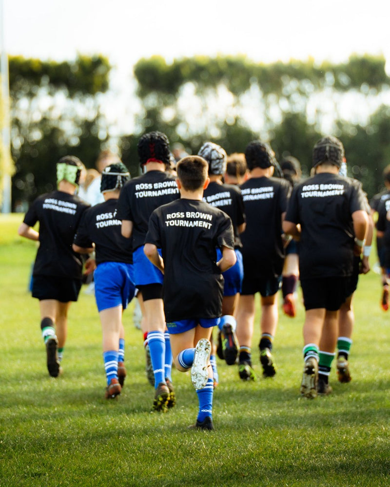 The squad runs out in Ross Brown Tournament warm up shirts